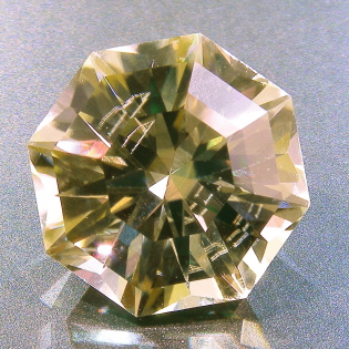 A faceted spodumene, with reflecting internal inclusion.